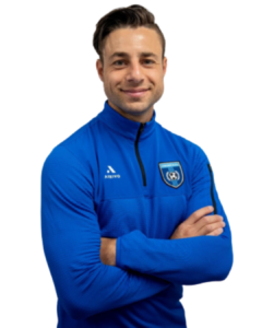 Chronis Elite soccer coach wearing a blue training jacket