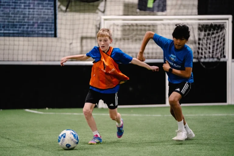 Youth soccer players competing for the ball during a Chronis Elite training session